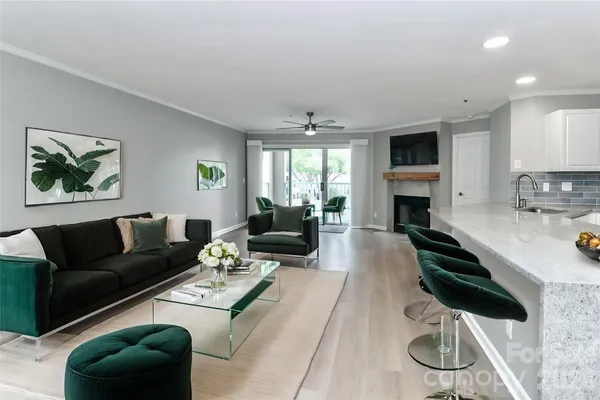 a living room with furniture a fireplace and a flat screen tv