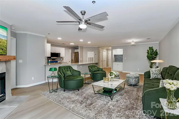 a living room with furniture and kitchen view