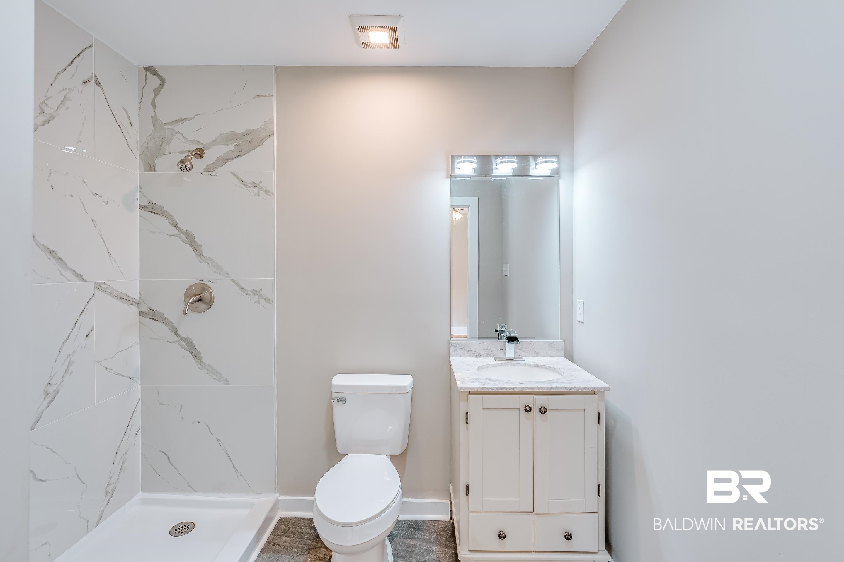 8001 16th Street Irvington, AL 36544 - Photo 23 of 35 Bathroom with vanity and a marble finish shower