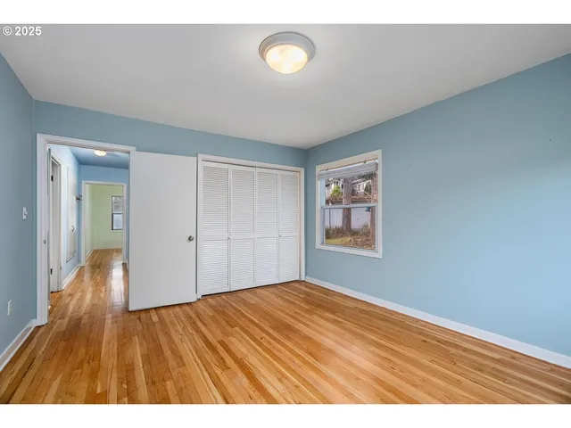 a view of an empty room and wooden floor