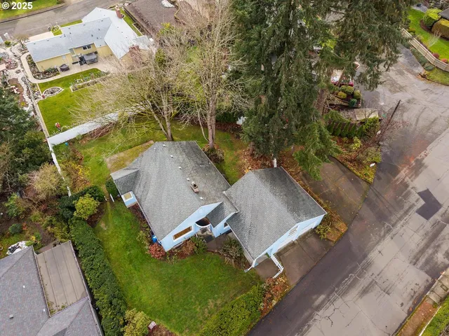 an aerial view of a house with a yard