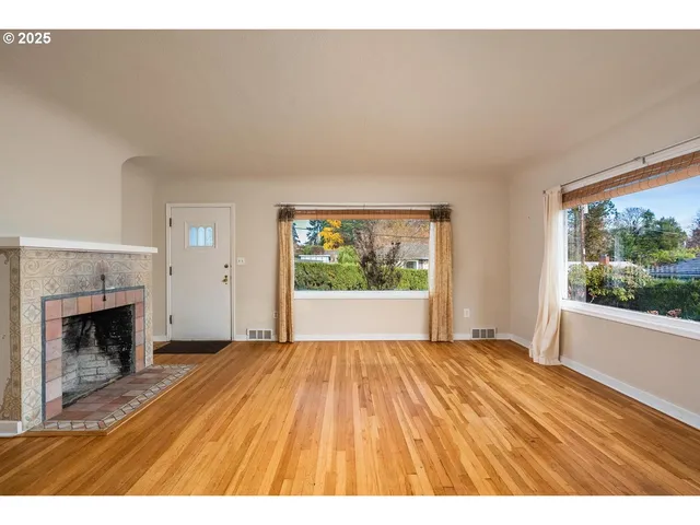 a spacious bedroom with a bed and a fireplace