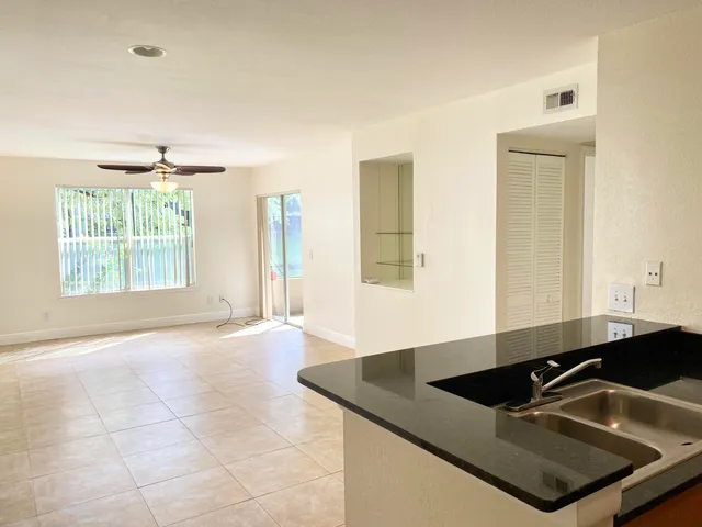 a kitchen with granite countertop a sink and a stove