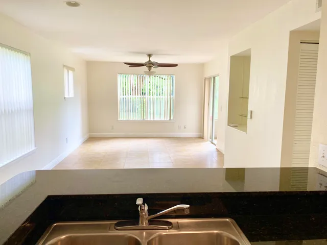 a room with pool table and windows