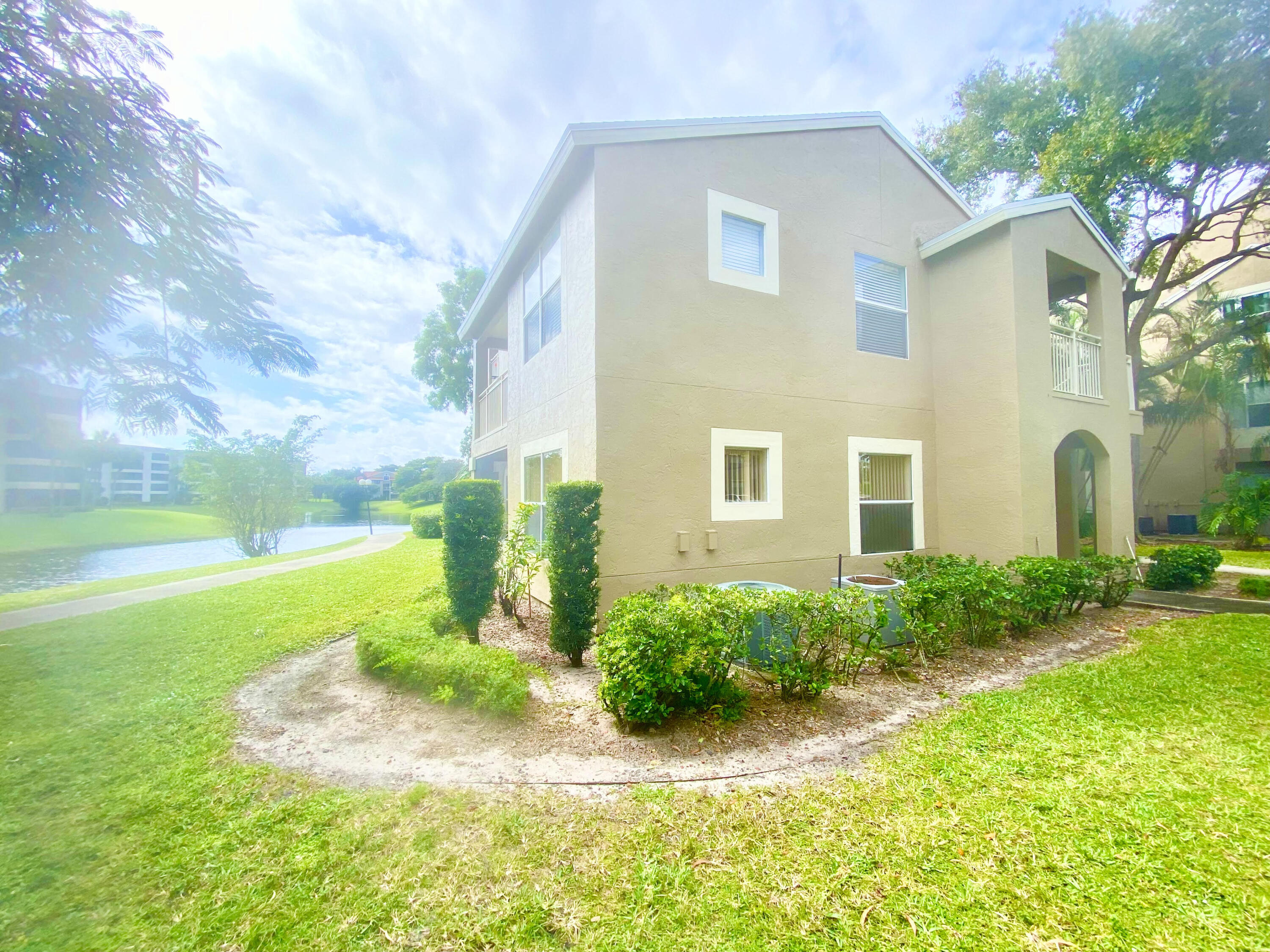 1745 Palm Cove Boulevard, Unit 3101 Delray Beach, FL 33445 - Photo 23 of 33 a view of a house with backyard and garden