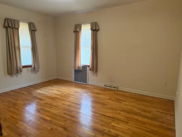 a view of empty room with a fireplace