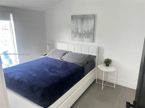 a bedroom with a bed and a table in it