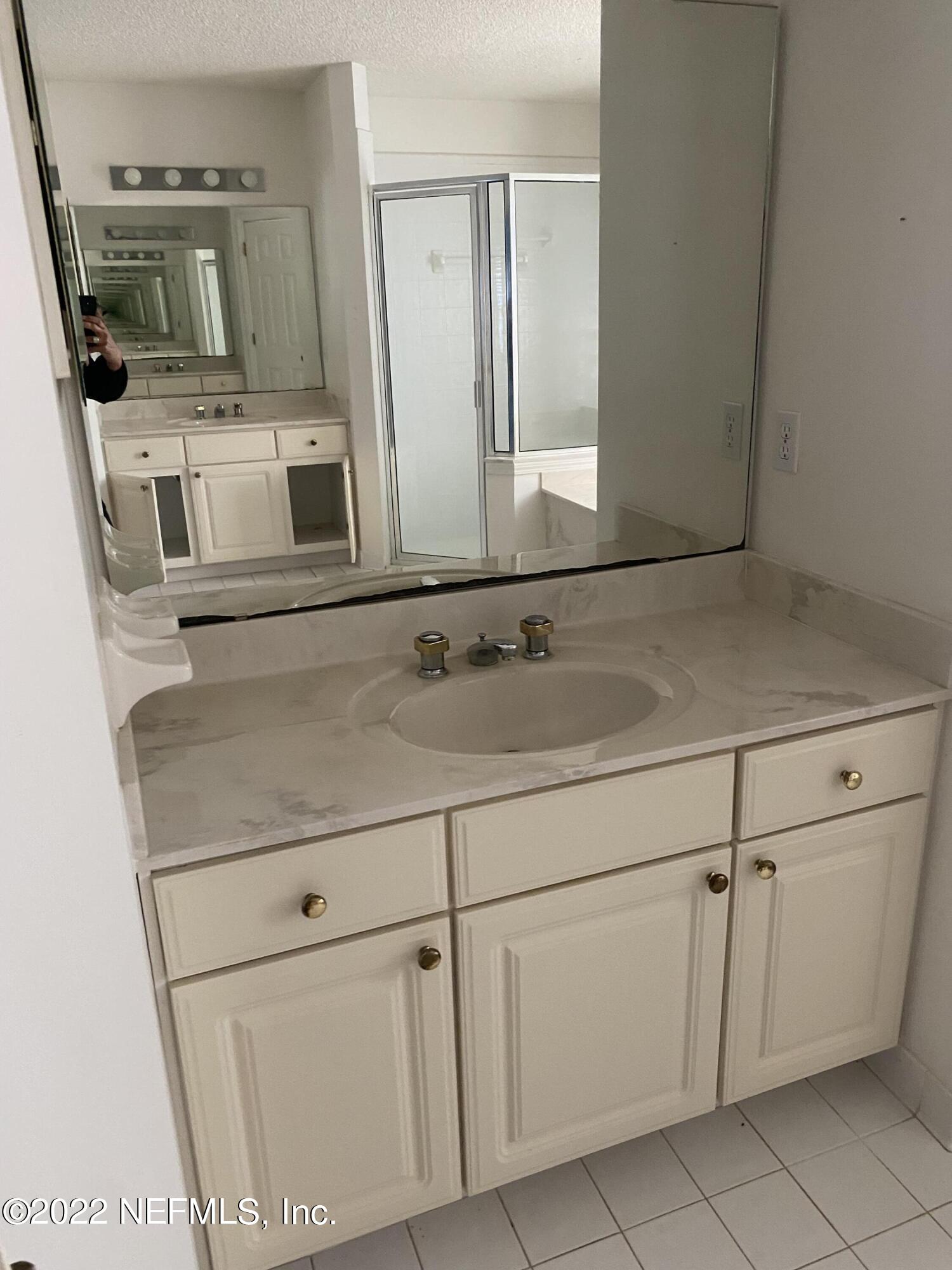 627 Cherry Street Neptune Beach, FL 32266 - Photo 12 of 17 a close view of a sink and a mirror in a room