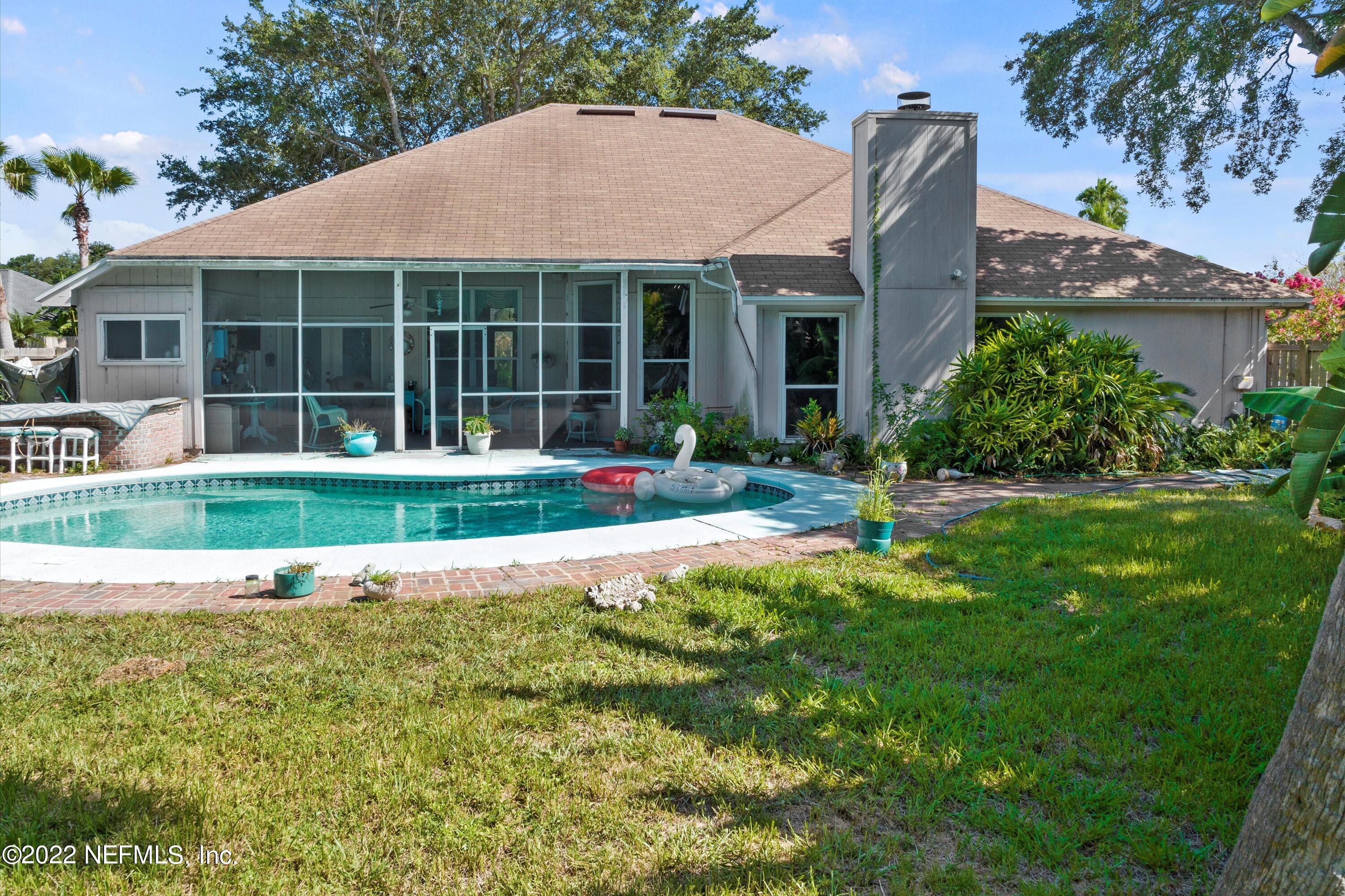 627 Cherry Street Neptune Beach, FL 32266 - Photo 3 of 17 a front view of a house with a yard and outdoor seating