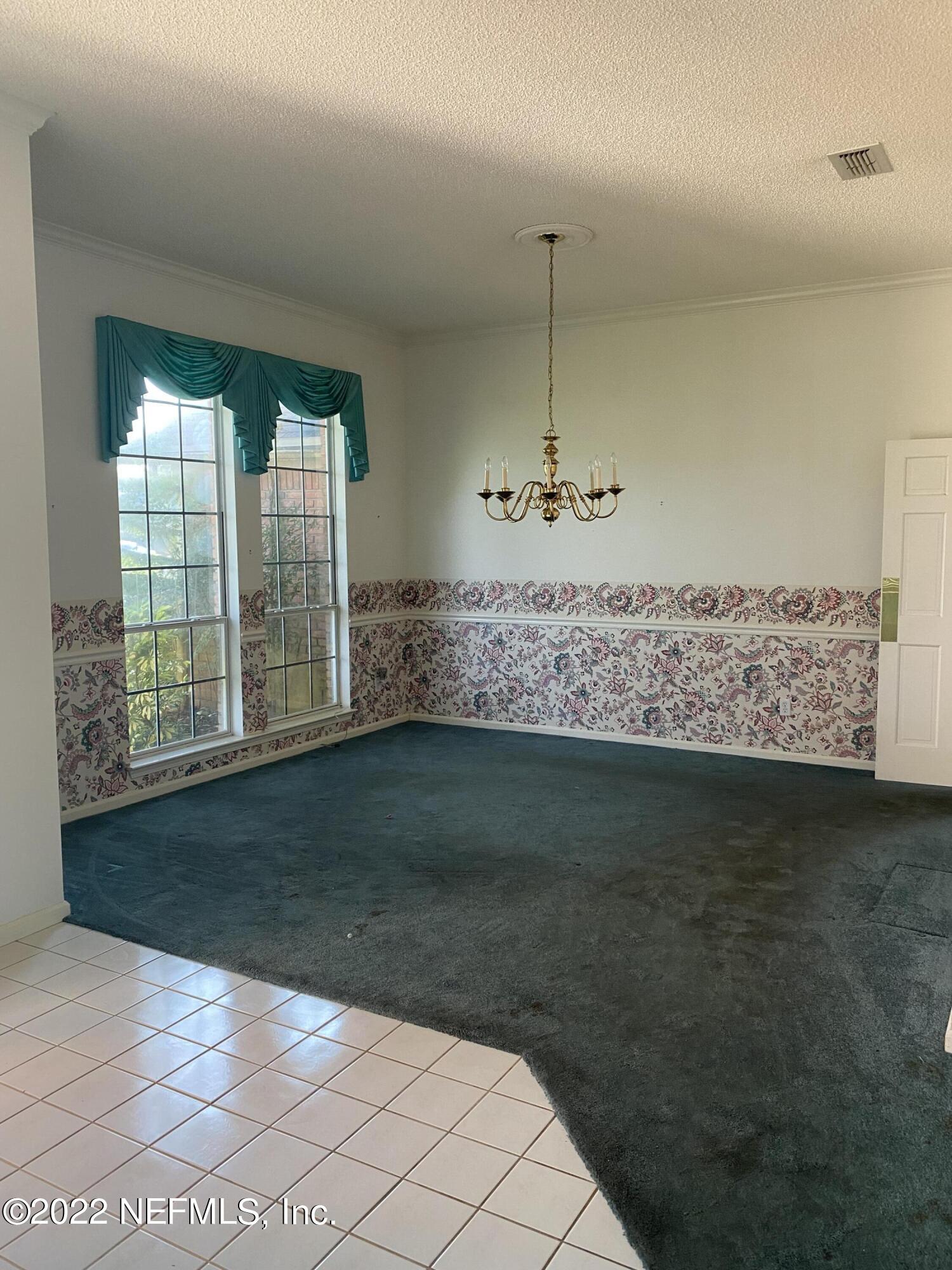 627 Cherry Street Neptune Beach, FL 32266 - Photo 9 of 17 a view of wooden floor and cabinet in a room