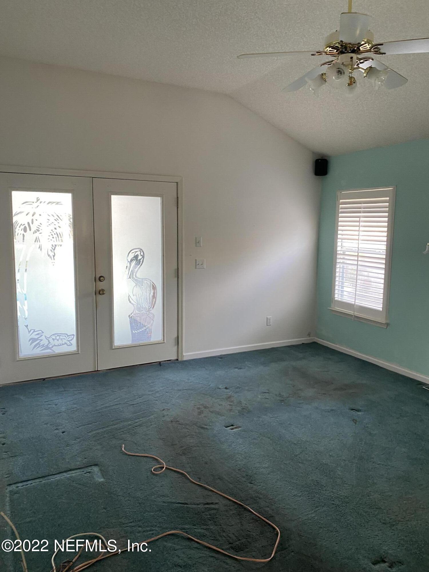 627 Cherry Street Neptune Beach, FL 32266 - Photo 10 of 17 an empty room with windows and ceiling fan