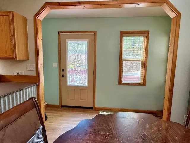 a kitchen with stainless steel appliances granite countertop wooden floors a sink and a large window