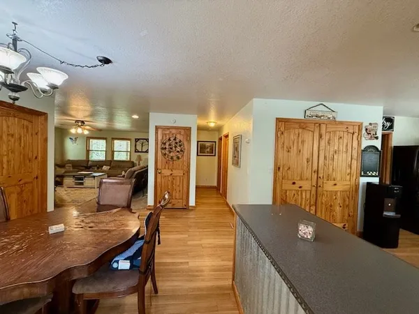 a kitchen with wooden floors a stove and a microwave
