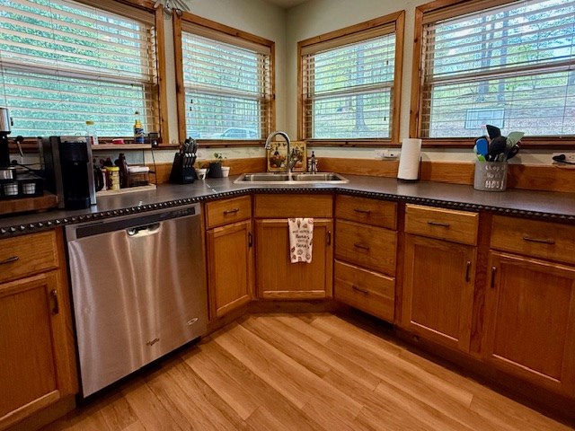 329 Tommy's Lane Murphy, NC 28906 - Photo 21 of 77 a kitchen with stainless steel appliances granite countertop wooden floors a sink and a large window