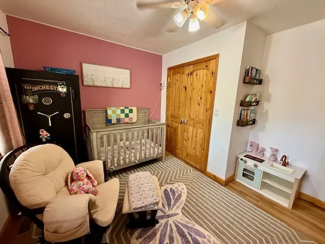 a spacious bedroom with a bed and a chandelier