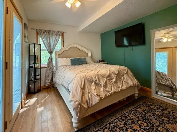a room with pool table and windows