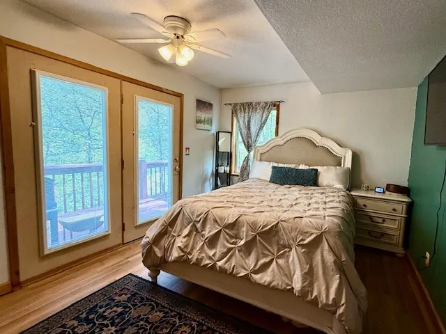 a bathroom with a sink a mirror a toilet and a window