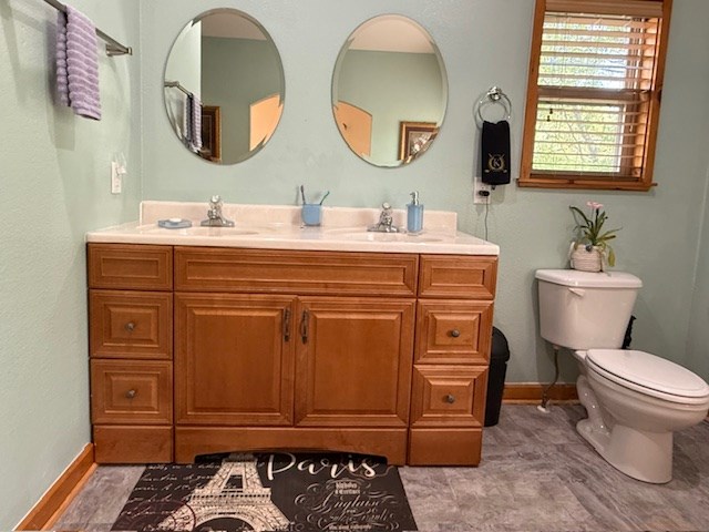 329 Tommy's Lane Murphy, NC 28906 - Photo 43 of 77 a bathroom with a sink a mirror a toilet and a window