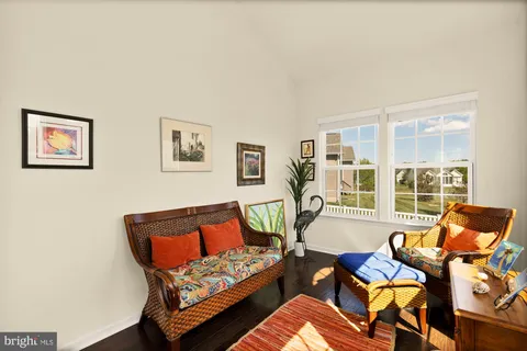 a bedroom with furniture and a large window