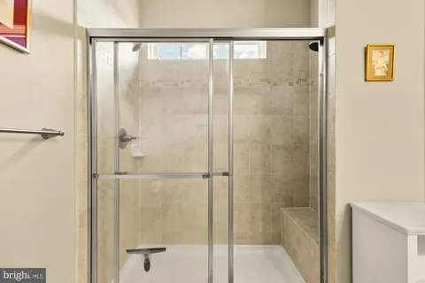 a bathroom with a glass shower door