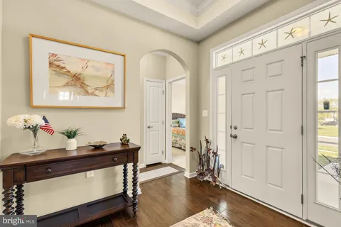 a view of a workspace room with wooden floor and window