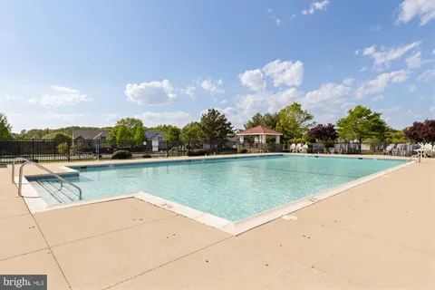 a view of swimming pool and trees in the background