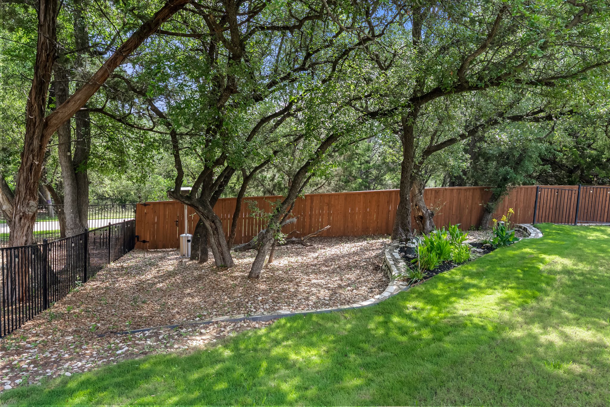 300 Prato Place Georgetown, TX 78628 - Photo 33 of 40 A well-maintained lawn and shaded yard offer a tranquil outdoor retreat.