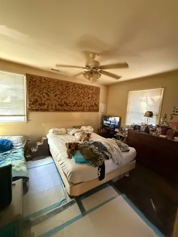 a bedroom with a bed and window