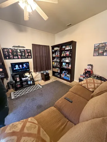a bedroom with furniture and a book shelf