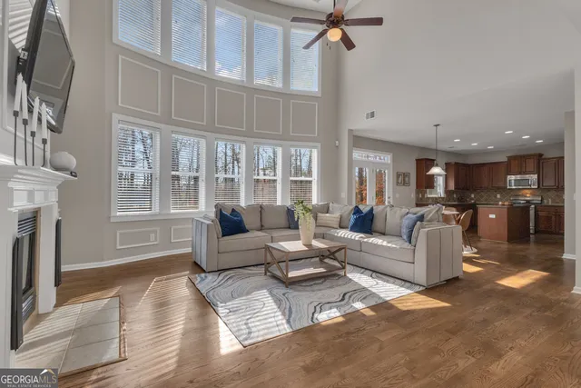 a dining room with furniture and wooden floor