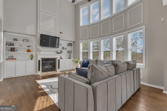 a kitchen with stainless steel appliances granite countertop wooden cabinets a refrigerator and a sink