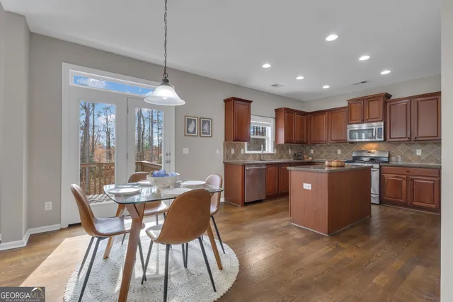 a kitchen with stainless steel appliances granite countertop a sink stove and microwave