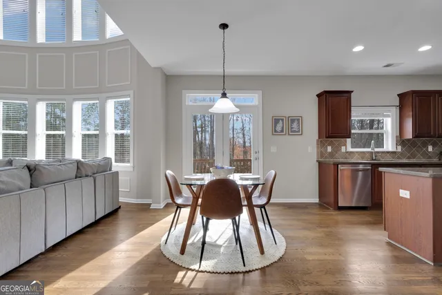 a kitchen with stainless steel appliances granite countertop wooden cabinets stove top oven and sink