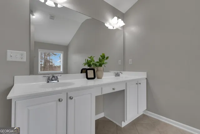 a bathroom with a granite countertop sink a toilet and a mirror