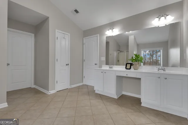 a bathroom with a shower curtain and window
