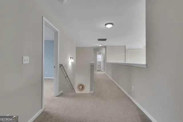 an empty room with ceiling fan and window