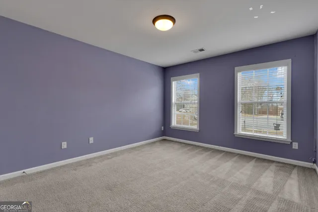 a view of a big room with table and chairs