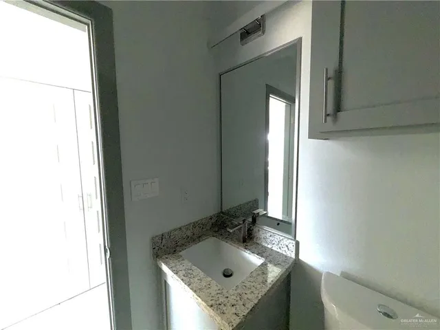 an empty room with a window and a ceiling fan