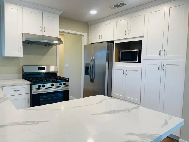 a kitchen with a stove and a refrigerator