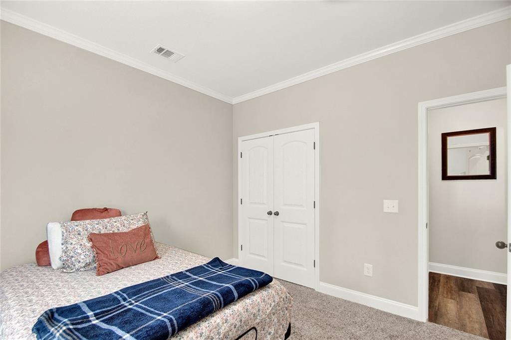 407 Corinth Church Road Winder, GA 30680 - Photo 30 of 66 a bedroom with a bed and wooden floor