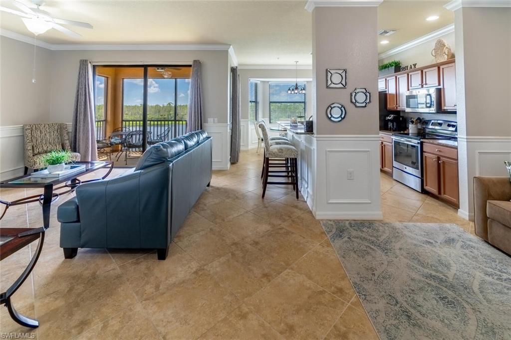 9731 Acqua Court, Unit 541 Naples, FL 34113 - Photo 4 of 48 a kitchen with furniture and a counter top space