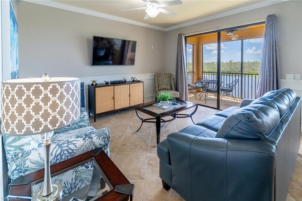 9731 Acqua Court, Unit 541 Naples, FL 34113 - Photo 5 of 48 a living room with furniture and a flat screen tv