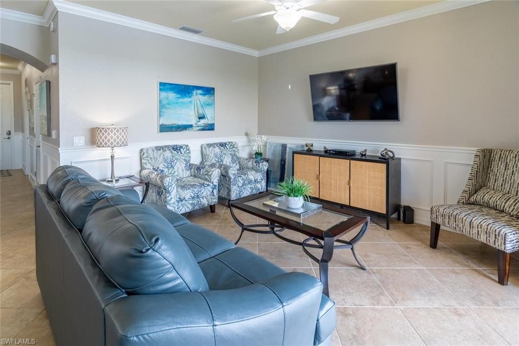 9731 Acqua Court, Unit 541 Naples, FL 34113 - Photo 7 of 48 a living room with furniture and a flat screen tv