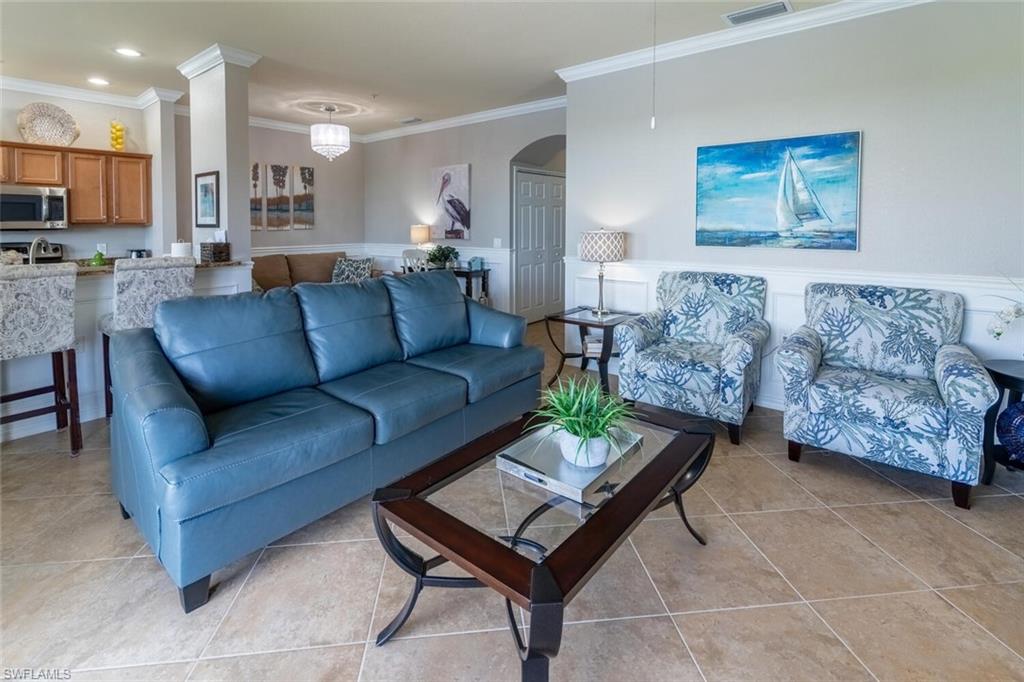 9731 Acqua Court, Unit 541 Naples, FL 34113 - Photo 8 of 48 a living room with furniture and a couch