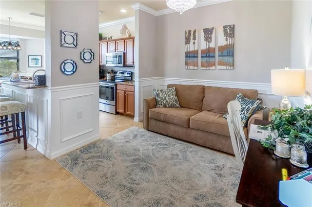 a living room with furniture and flowers