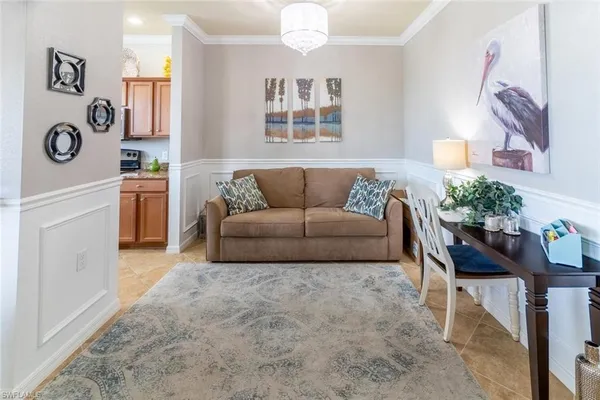 a living room with furniture and a chandelier