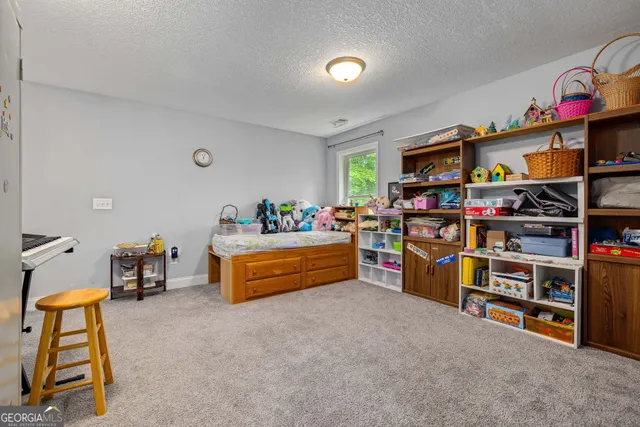 a room with lots of books and a baby crib