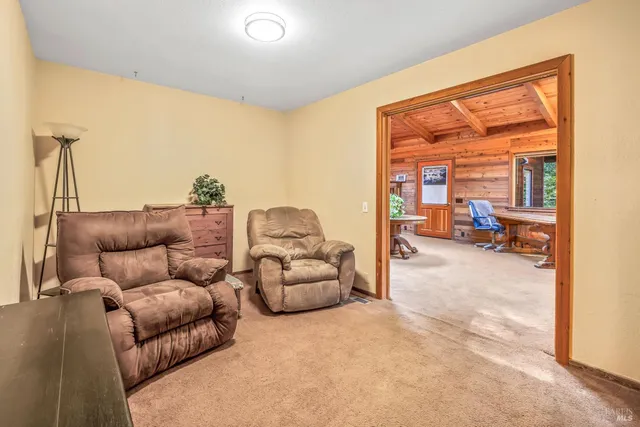 a living room filled with furniture and a large window