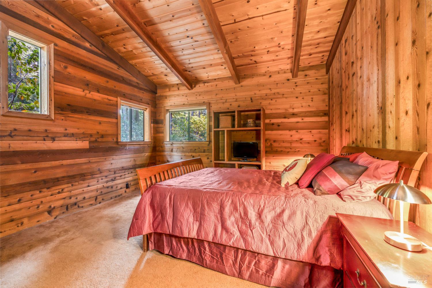 17451 Redwood Springs Drive Fort Bragg, CA 95437 - Photo 18 of 43 a bed sitting in a bedroom next to a window