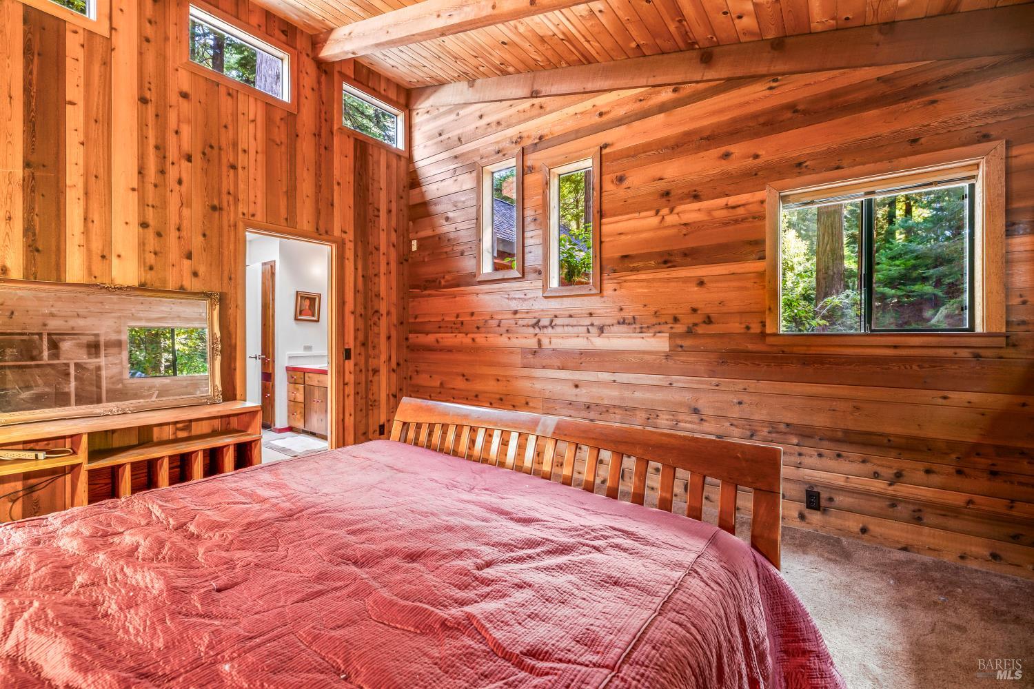 17451 Redwood Springs Drive Fort Bragg, CA 95437 - Photo 19 of 43 a bedroom with a bed and a large window